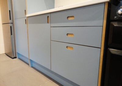 Plywood Kitchen with blue laminate doors and Handy recessed handles by The Life of Ply