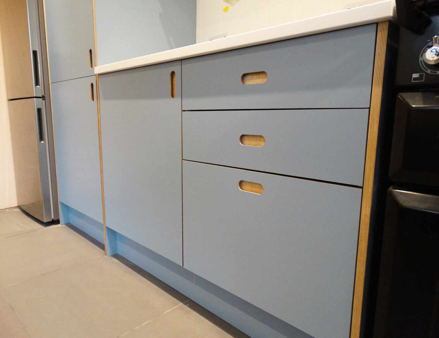 Plywood Kitchen with blue laminate doors and Handy recessed handles by The Life of Ply